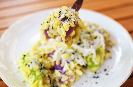 Mouthwatering Thai Dessert of Sticky Rice and Mung Beans Dumplings Sprinkled with Sugar and Sesame Seeds Called Khanom Tua Papの写真素材