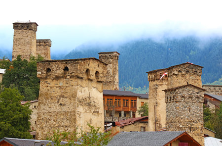 Group of Ancient Svan Tower-houses in the Mist, Incredible UNESCO World Heritage Site in Mestia, Svaneti Region of Georgiaの写真素材