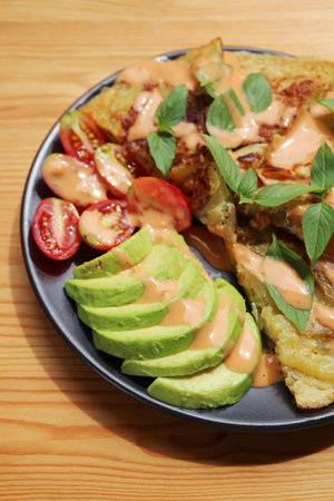 Plate of Homemade avocado and Tomato Salad with Spanish Omelette or Tortilla Espanolaの写真素材