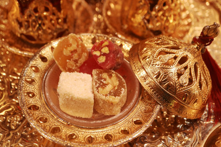 Closeup of Mouthwatering Assorted Turkish Delights with Blurry Turkish Tea in the Backdropの写真素材