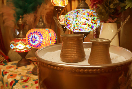 Closeup of Turkish Coffee Boilers Called Cezve Placed on the Hot Sandの写真素材