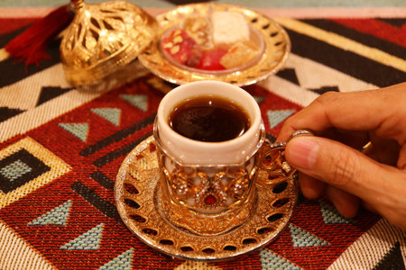 Cup of Hot Turkish Coffee with Blurry Turkish Delights in the Backdropの写真素材