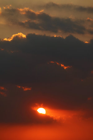 Stunning bright shining on the orange red cloudy skyの写真素材