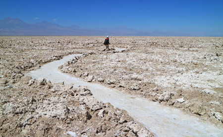 Visitor on the trail among Salar de Atacama, an amazing Chilean salt flat in Antofagasta region, northern Chile, South Americaの写真素材