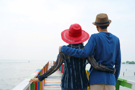 Couple Enjoy Walking on a Waterfront Wooden Boardwalkの写真素材