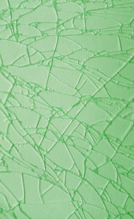 Artistic pattern of light green cracked glass surface