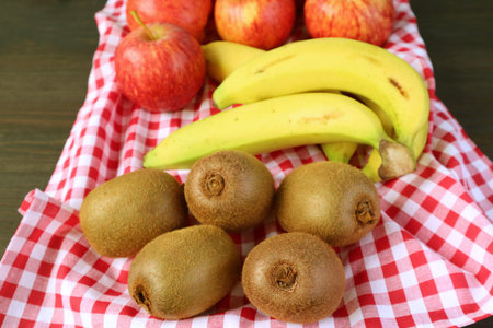 Heap of Fresh Ripe Assorted Fruits on Checkered Tableclothの写真素材