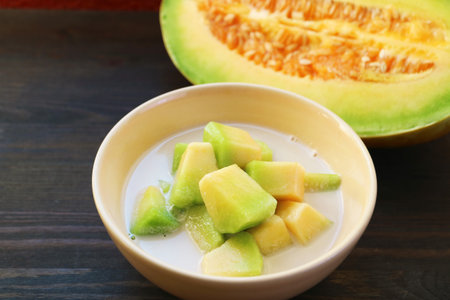 Tasty and Fragrance Thai Melon in Chilled Sweetened Coconut Milk with Fresh Fruit in the Backdropの写真素材