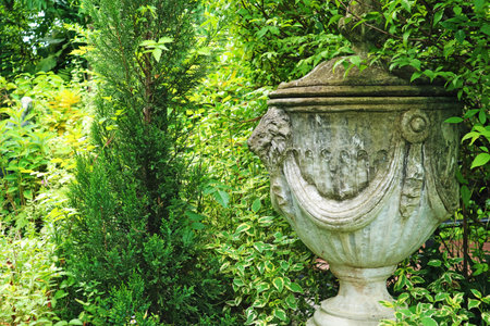 Gorgeous Old Stone Roman Vase Sculpture in a Gardenの写真素材