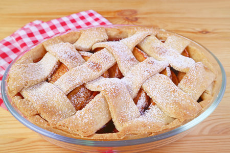 Mouthwatering freshly baked tasty and healthy apple pie on wooden tableの写真素材
