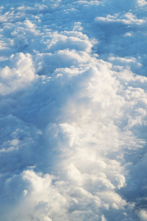 Stunning sea of clouds view from the plane window during flight