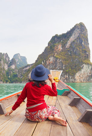 Female Visitor Enjoy Boating on Picturesque Cheow Lan Lake or Ratchaprapa Dam in Khao Sok National...