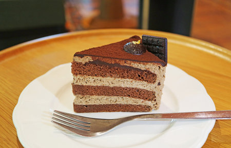 A Slice of Delectable Rich Chocolate Chiffon Cake Served on Wooden Table