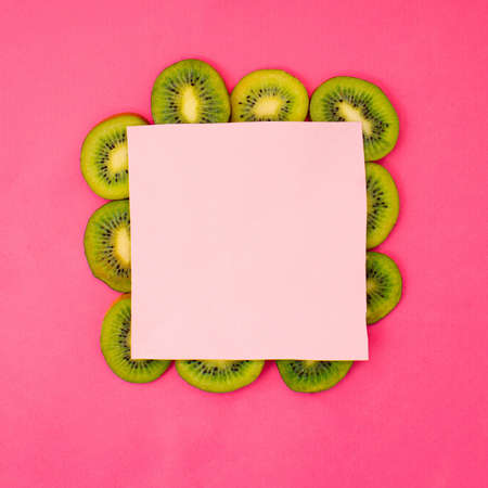 Space for text on kiwi slices. Creative concept on pink background.の写真素材