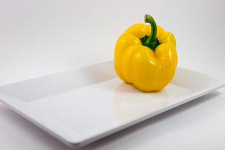 Yellow pepper with white dish