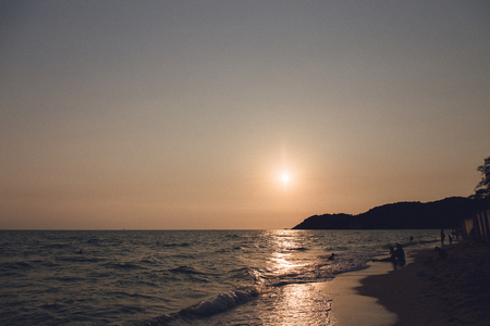 Silhouette  on the beach at sunsetの写真素材