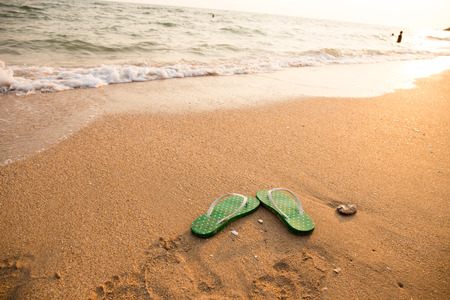 Flip flops on beach oceanの写真素材