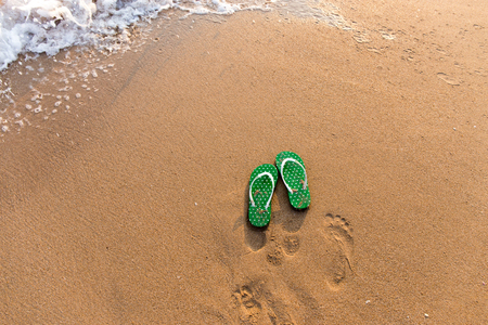 Flip flops on beach oceanの写真素材