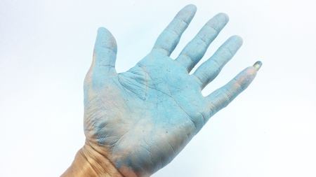 hand in blue enamel color on white backgroundの写真素材