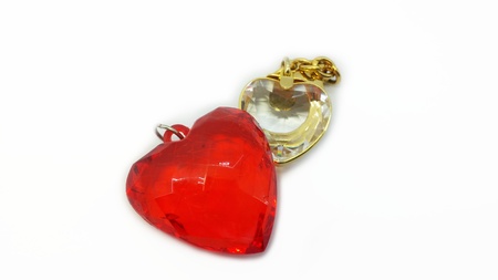 Red and clear heart shape pendants on white backgroundの写真素材