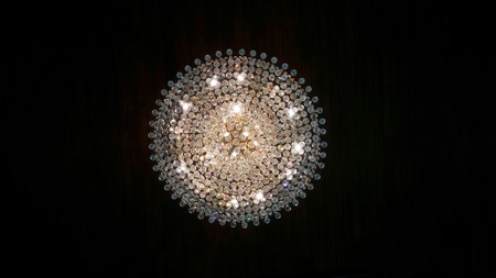 Crystal chandelier on wooden ceilingの写真素材