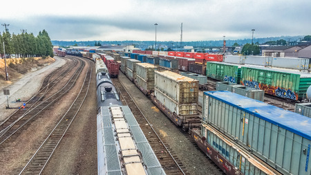 Seattle, Washington, USA - July 27, 2015: trains carry containers and oil tanks stop and wait to unload at Balmer Yard, Seattle, Washington, USA.のeditorial素材