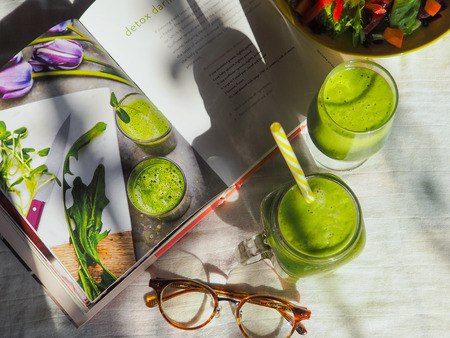 BANGKOK, THAILAND - FEBRUARY 2, 2017: the morning sunlight creates shadows of smoothie cups appearing on the book  'Crazy Sexy Juice' written by Kris Carrのeditorial素材