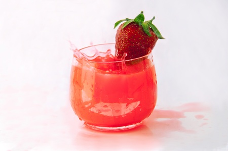 Strawberry juice with fruit on a glassの写真素材