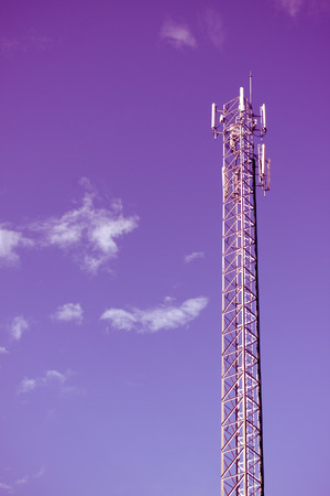 antenna repeater tower on blue skyの写真素材