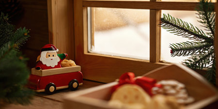 Festive holiday decorations with Santa figure on windowsill and snow outsideの素材