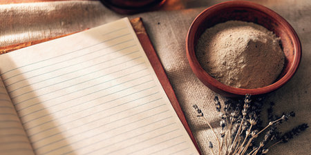 Blank lined notebook page with rustic bowl and dried herbs.の素材