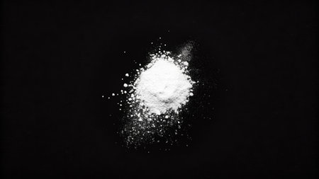 White powder isolated on black background. Top view. Flat lay.の素材