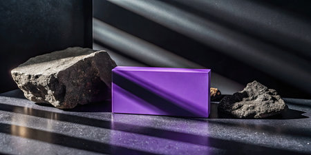 Purple stand on a black background with stones.の素材