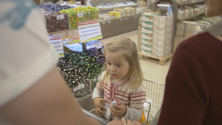 Happy family makes purchases in the supermarketの写真素材