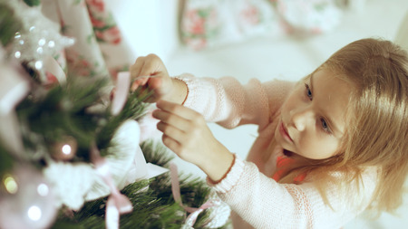 Family consists of females sitting around the Christmas tree with giftsの写真素材