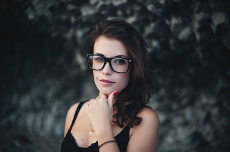 Sexy model in glasses and wearing the dress posing near the cliffの写真素材