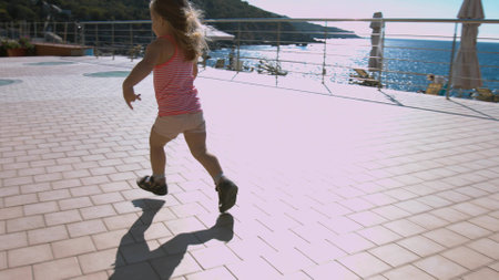 Little girl running to parents in the parkの写真素材