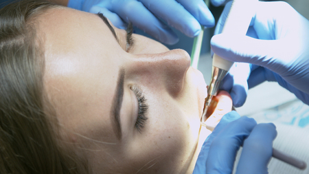 Beautiful girl on the examination by the doctor dentistの写真素材