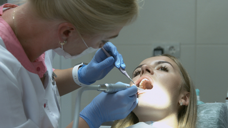 Medical dentist procedure of teeth polishing with cleaning from dental deposit and odontolithの写真素材