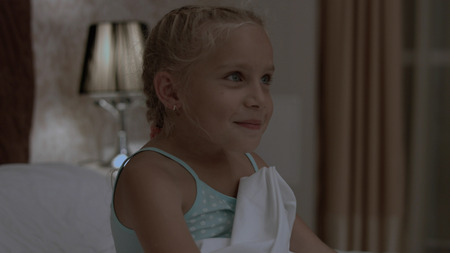 Little girl is trying to sleep in her bedの写真素材