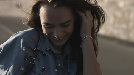 Pretty young girl walk along the roadの写真素材