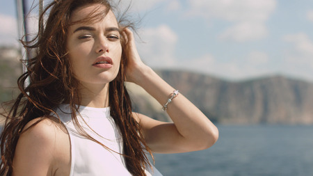 Beautiful young sexy brunette girl on the yachtの写真素材