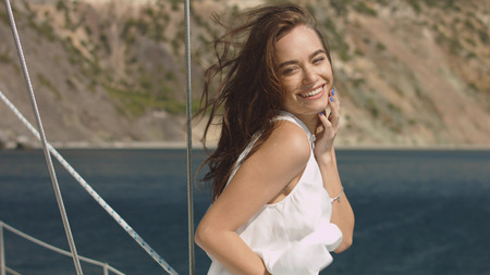 Young beautiful brunette girl on the luxury yachtの写真素材