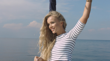 Woman sailing in a yacht on her summer holidaysの写真素材