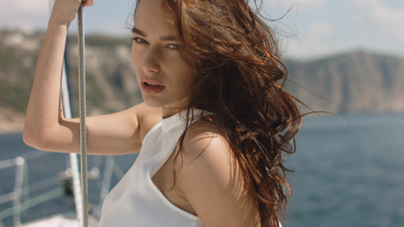 Beautiful young sexy brunette girl on the yachtの写真素材