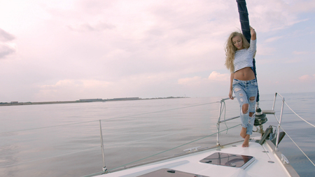 Sexy long hair girl on yachtの写真素材