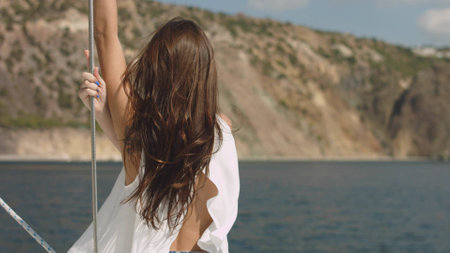 Young beautiful brunette girl on the luxury yachtの写真素材