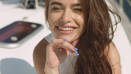 Young sexy brunette girl on the yachtの写真素材