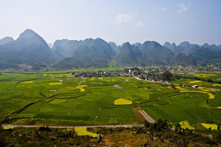 Small Village in Grassland surround with beautiful mountains in Kunming, China. 