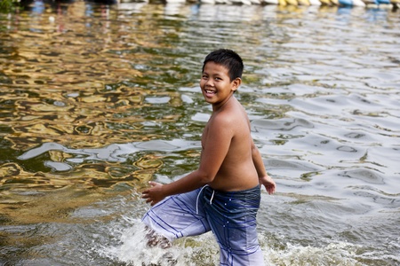 Bangkok, Thailand - November 5, 2011: A Child swimming during the flooding in Bangkok.のeditorial素材